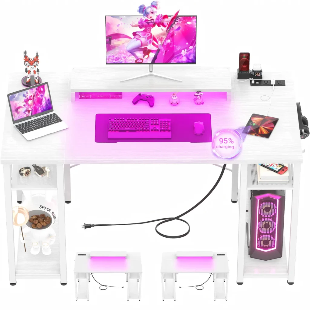 Top down view of a 55.2 inch 140cm white gaming desk with pink led lights hosting laptop and desktop computer setup