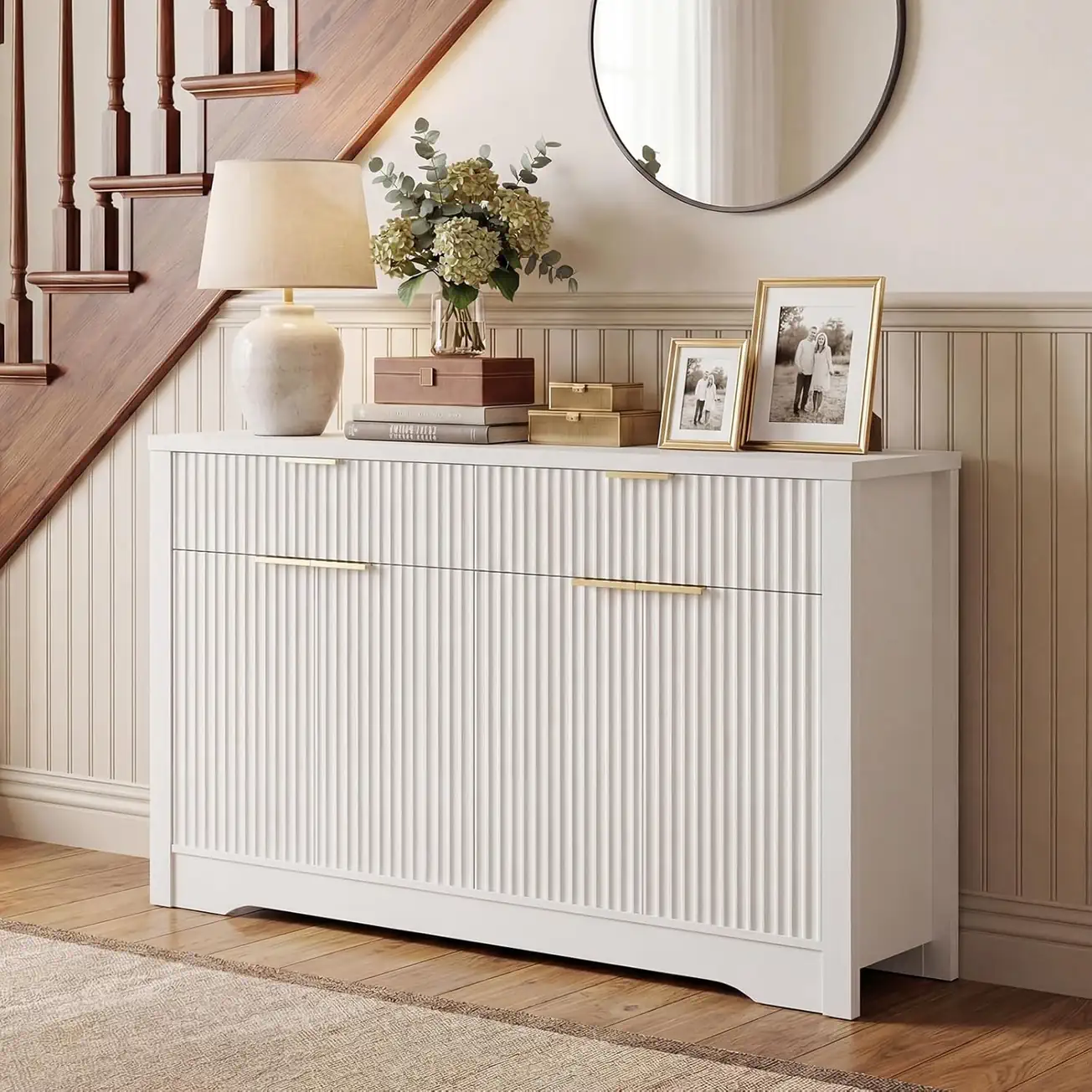 White Fluted Sideboard Cabinet Entryway Lifestyle Scene Wholesale modern white fluted sideboard buffet cabinet lifestyle setup in a hallway entryway scene, minimalist console table with gold handles under a round mirror