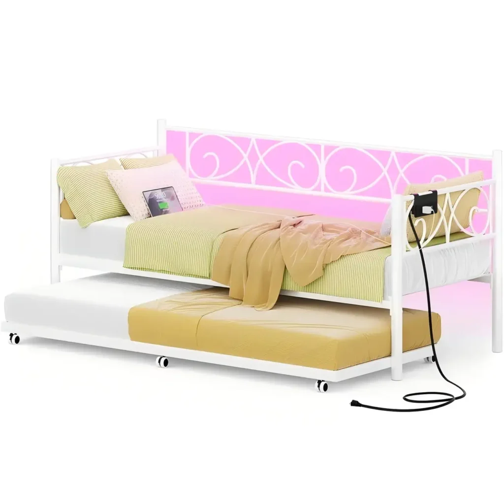 Elegant white metal daybed frame with a floral pattern backrest featuring pink LED lighting, a hanging side charging station, and an underneath rolling trundle bed