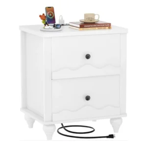 Modern white wooden nightstand with two scalloped drawers and black knobs on a pure white background, featuring an integrated top charging station with devices charging