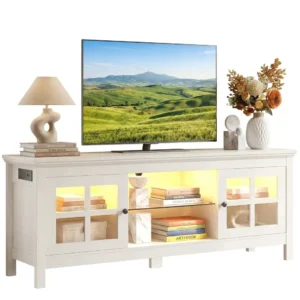 Modern white TV stand and media console featuring glass-paneled doors, adjustable central glass shelf, built-in LED ambient lighting, and a side-mounted electrical power strip